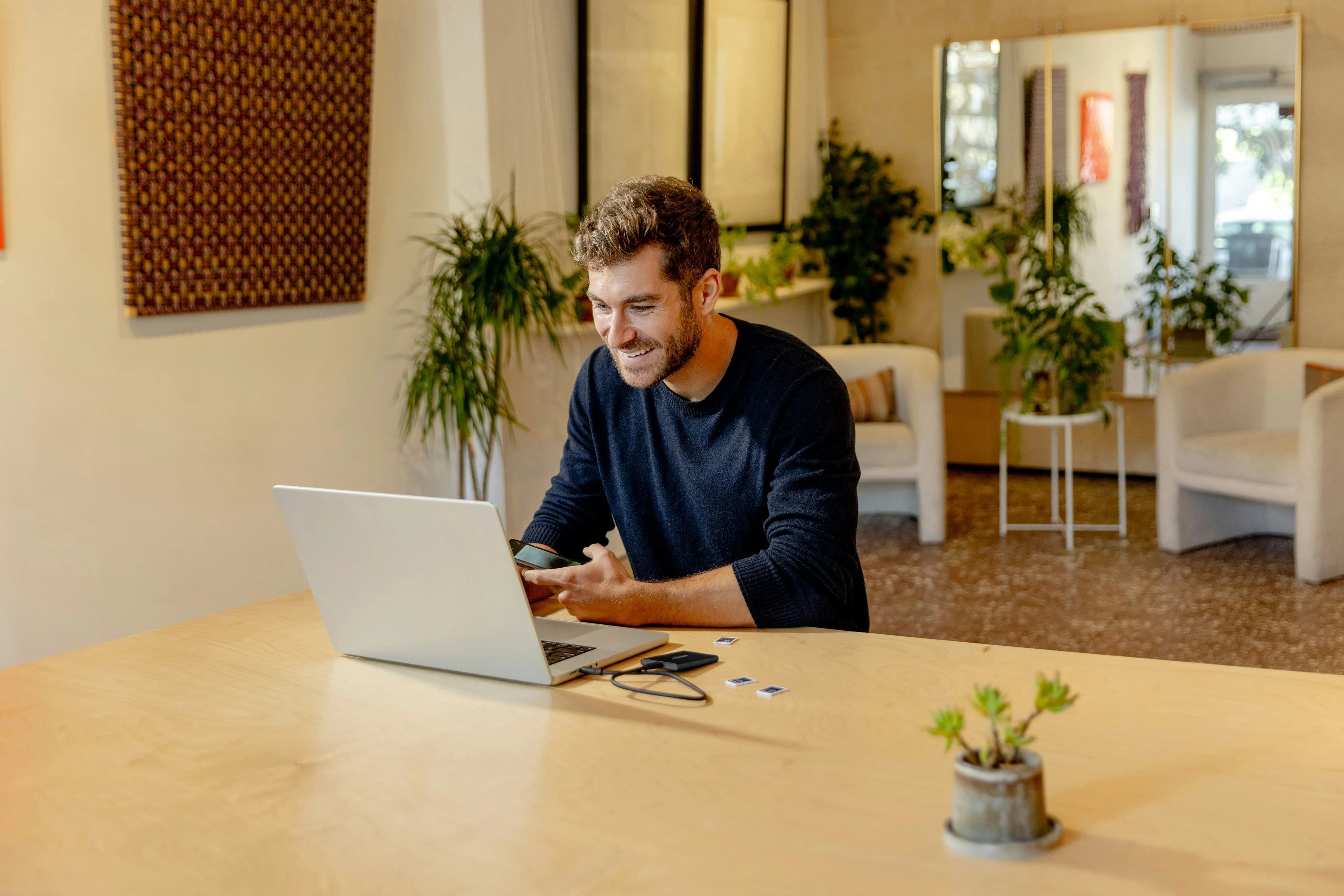 Man working on a laptop, reviewing his finances